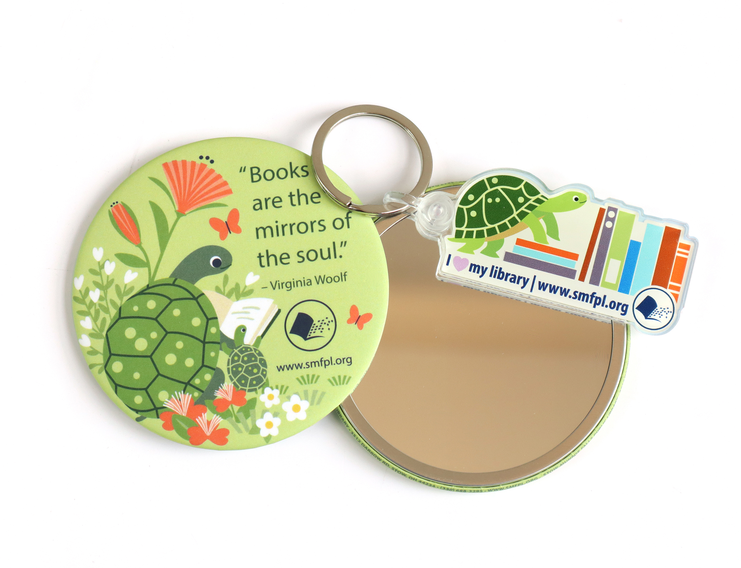 Acrylic keychain with an illustration of a smiling turtle climbing a stack of books. The text reads: I heart my library. www.smfpl.org, and a 3-inch pocket mirror illustrated with a larger turtle reading to a smaller one.